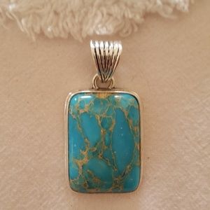Tourqous pendant with silver slide.
